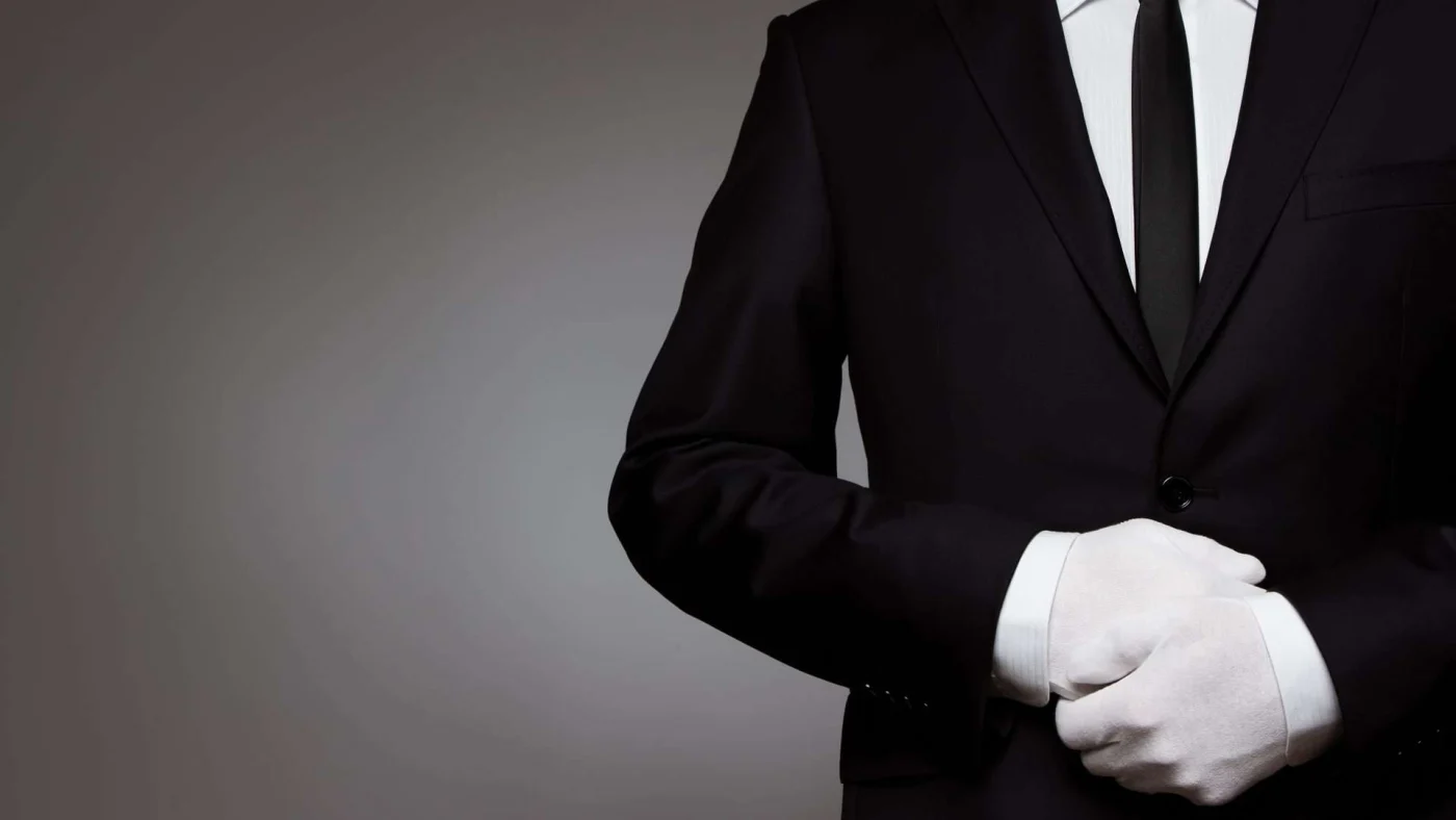 Concierge Window Fashions Service San Francisco Bay Area The Home Living Company A person in a suit with white-gloved hands stands at attention, waiting for directions