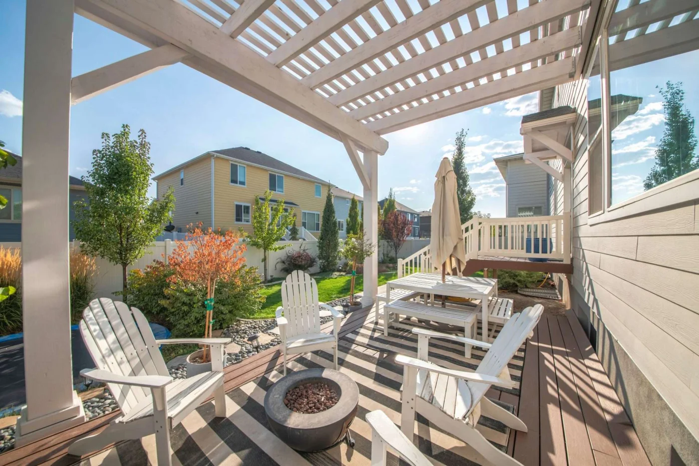 Backyard in San Pablo, CA with white pergola and porch furniture | The Home Living Company