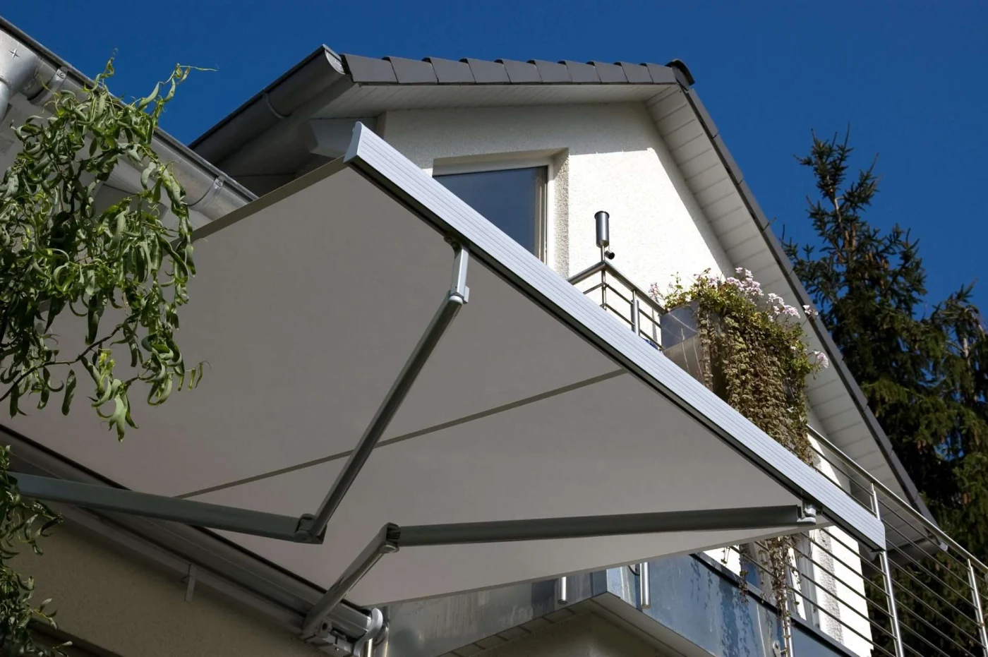 Gray retractable awning attached to the side of a house San Pablo, CA | The Home Living Company