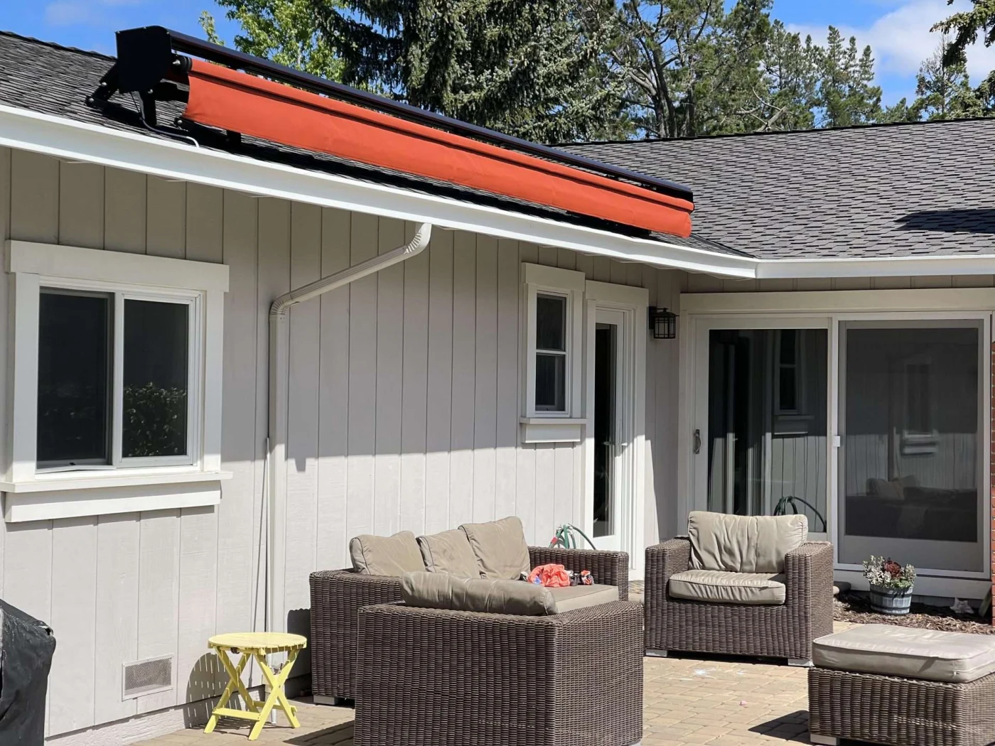 Red retractable awning located on patio of home in Sausalito, CA | Home Living Window Fashions