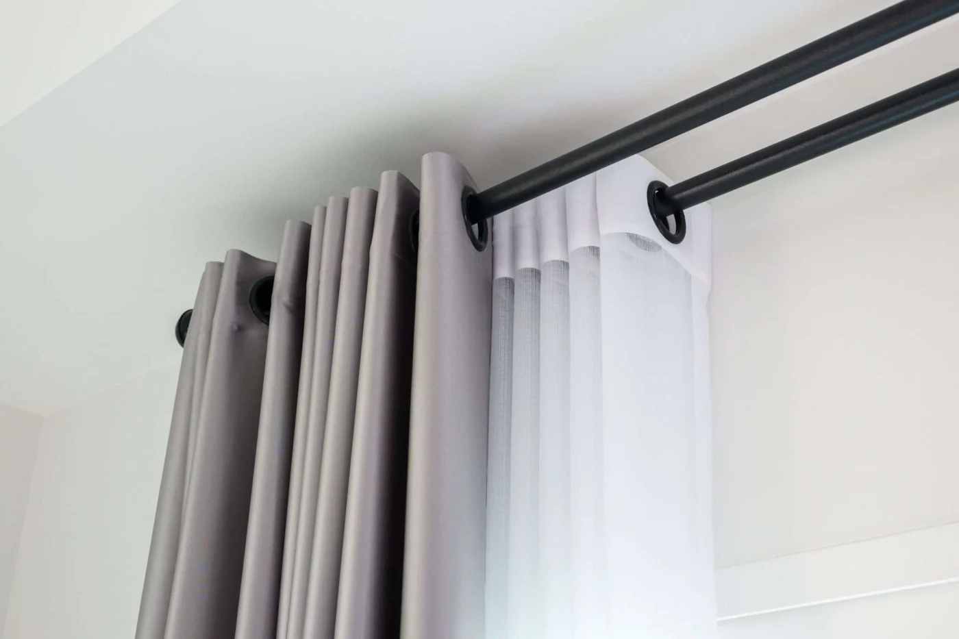 Sheer curtains and light gray drapes on windows in San Rafael, CA by The Home Living Company