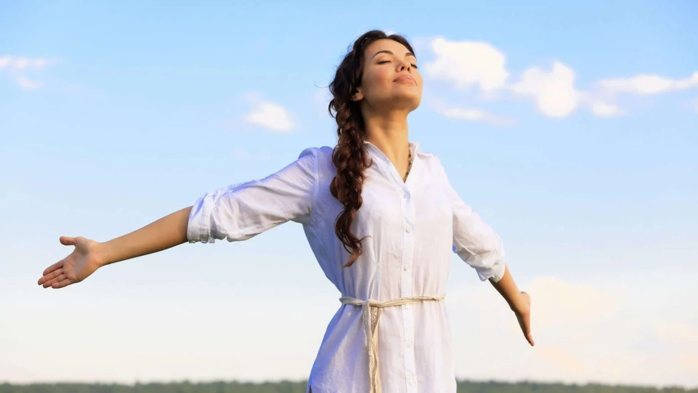 Premium Window Fashions San Francisco Bay Area The Home Living Company A woman stands with her arms spread wide as she takes a deep breath of fresh air