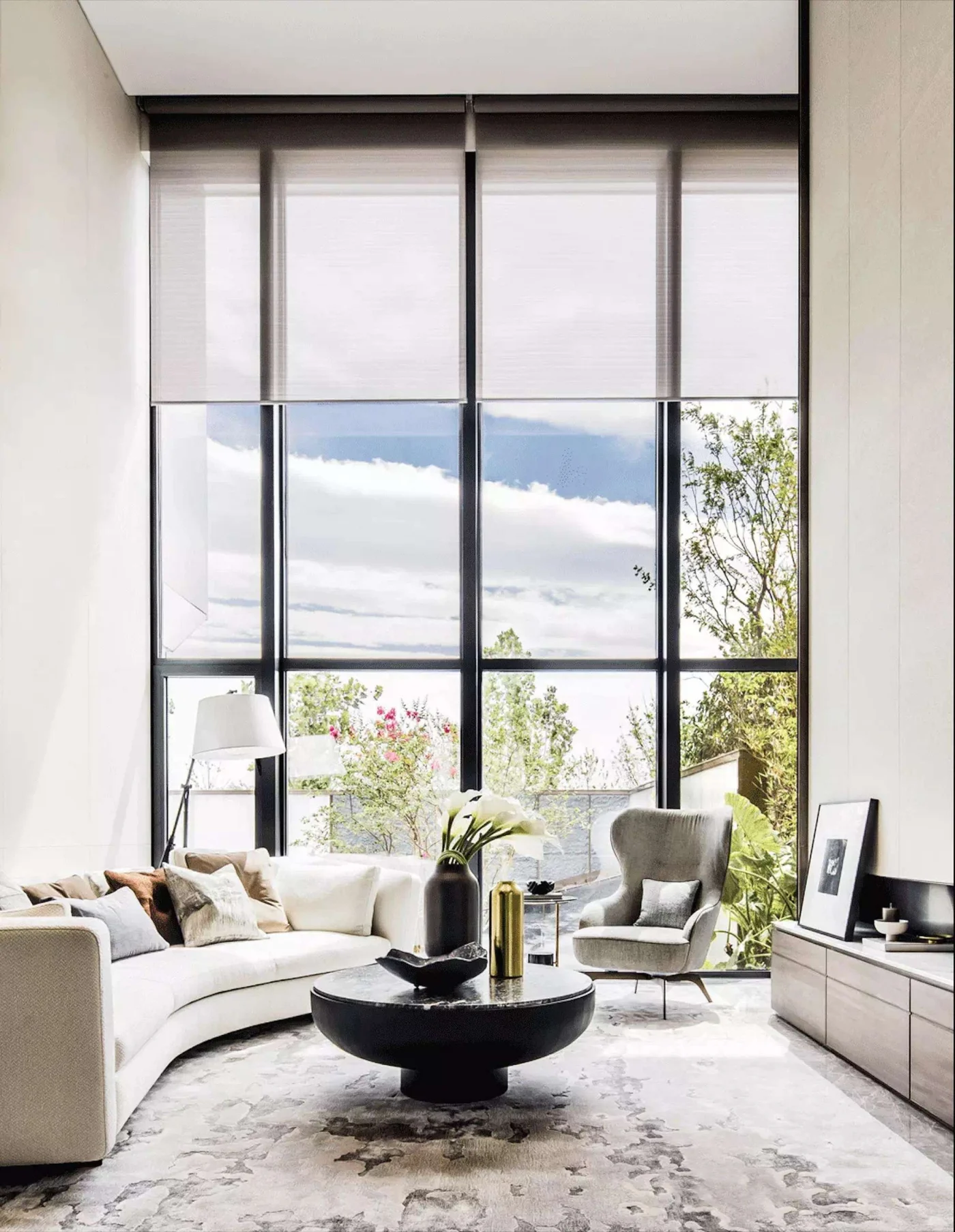Motorized shades installed on tall windows in home