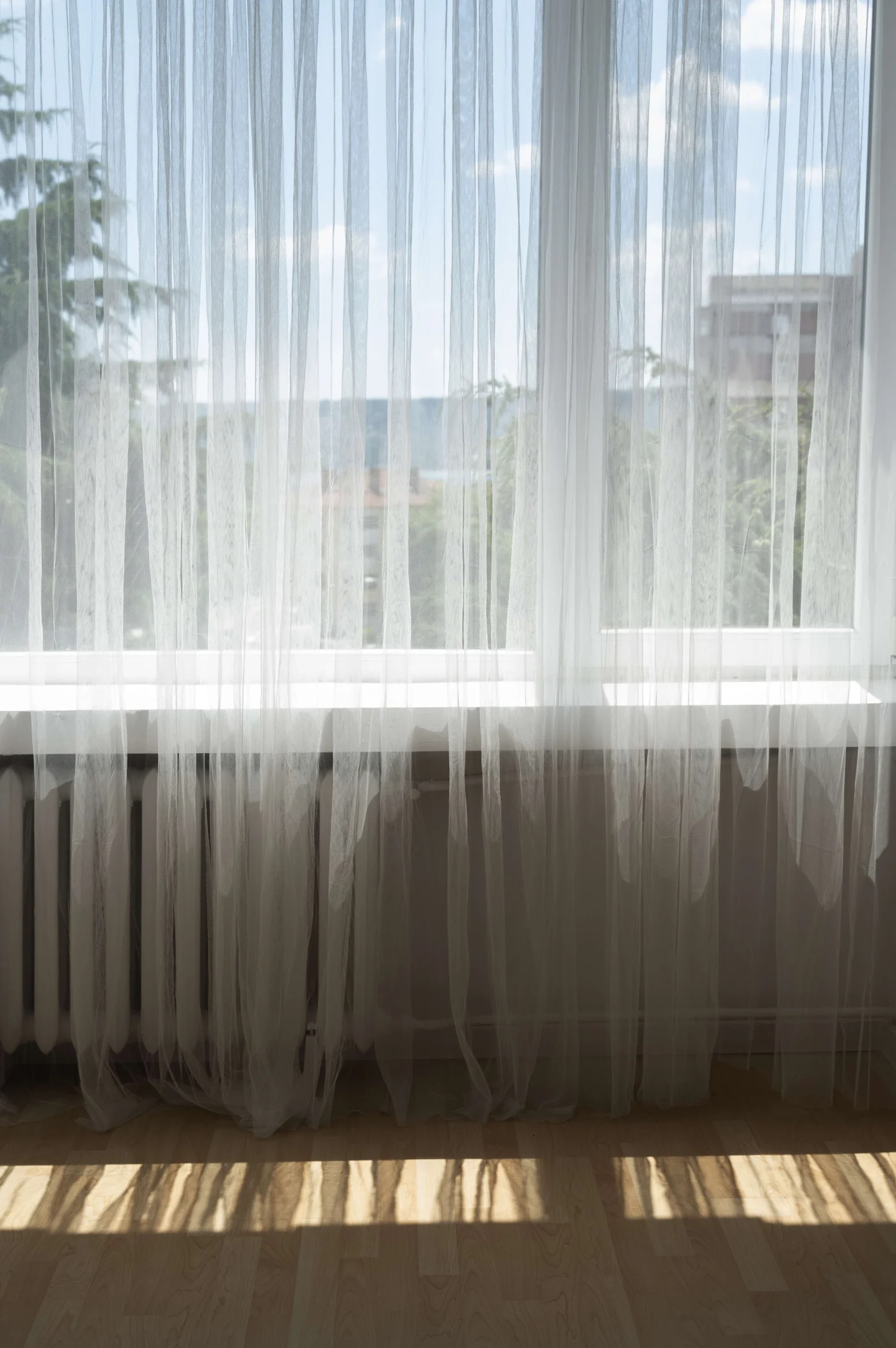 Sustainable Window Treatments In Lafayette, CA | Home Living Window Fashions A spacious window in a Bay Area home with thin, gauzy curtains.